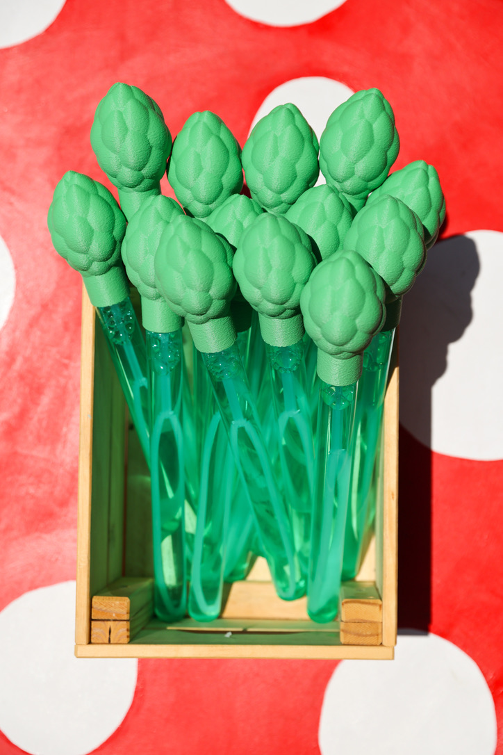 A bunch of asparagus bubble wands in a crate